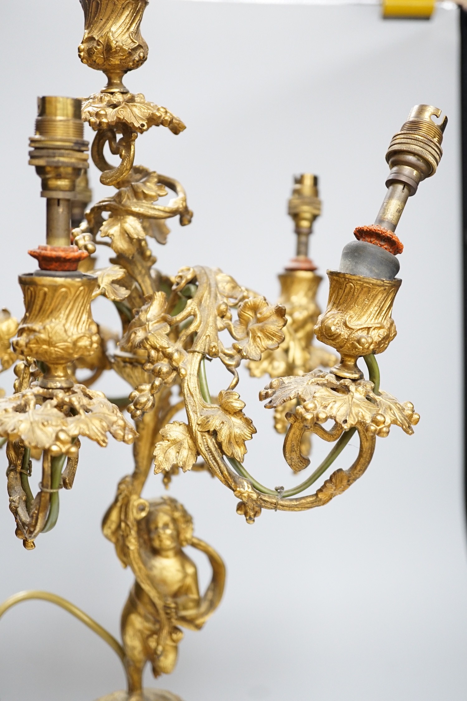An ornate six branch ormolu cherub candelabrum, converted to a lamp, 54cms high